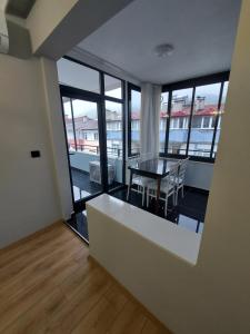 a view of a room with a table and some windows at ÇOLAK SUIT in Arsin