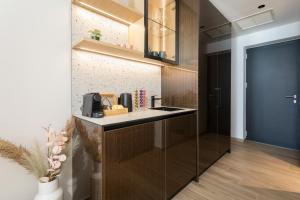 a kitchen with a counter and a blue door at Akrogiali Luxury View in Laganas