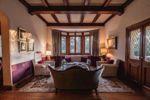 a living room with a couch and a table at Scratch House hotel boutique in Villa Allende