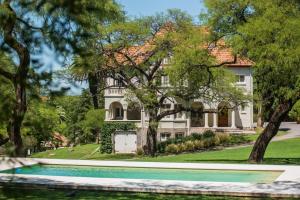 a house with a swimming pool in front of it at Scratch House hotel boutique in Villa Allende
