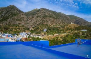 a view of the mountains from the roof of a building at CASA TROUSSI in Chefchaouene