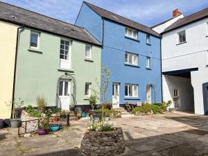 a row of colourful houses with a courtyard at 1 Cromwells Cottage-uk40925 in Pembroke