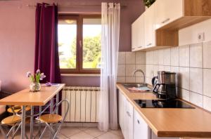 a small kitchen with a table and a window at Apartman Studio in Pula