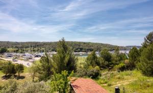 a view of a marina with trees and a building at Apartman Studio in Pula