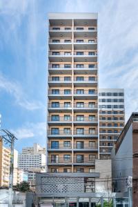 a tall building with many windows in a city at Loft Grid Liberdade in São Paulo