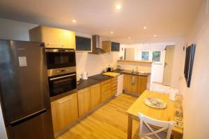 a kitchen with a black refrigerator and a table at Cascais Getaway with a shared pool in Cascais