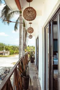 a balcony with potted plants and hanging lights at Hotel y Beach Club Casa Mia Xulha -Bacalar in Xul-Ha