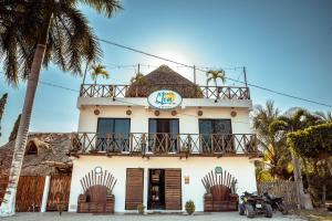 a building with a sign on top of it at Hotel y Beach Club Casa Mia Xulha -Bacalar in Xul-Ha