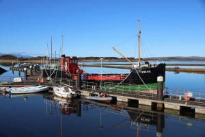 a boat docked at a dock with boats in the water at Marina View Guest House in Irvine