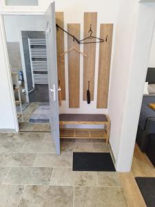 a hallway with a door and a tile floor at Holling apartman in Fertőboz +36 photos