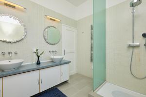 a bathroom with two sinks and a shower at La Villa Lopud- Breakfast & Dinner Included in Lopud
