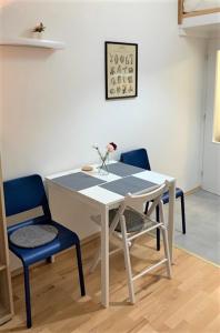 a white table and chairs with a vase on it at Side Street Apartments in Prague