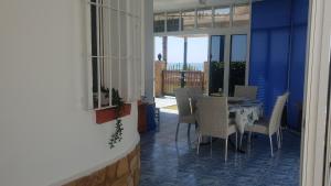 a dining room with a table and chairs on a balcony at Casita Beach Front in Torrox Costa