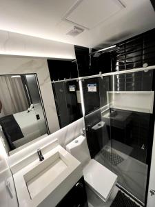a bathroom with a sink and a mirror at Pousada do Braga in Cabo Frio +65 photos