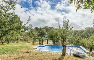 a swimming pool in a field with a tree at Nice Home In Diomondi With Outdoor Swimming Pool in Diomondi