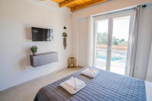 a bedroom with a bed with two pillows on it at Elianthos Luxury Villas in Tsoukalades +65 photos