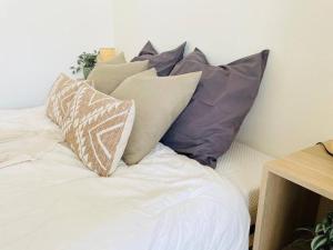 a bunch of pillows sitting on a bed at Spacious 1 bed in the Heart of City Center - 21 in Luxembourg