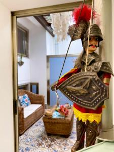 a statue of a man wearing a shield and holding an umbrella at Alpha22 Apartment in Giardini Naxos