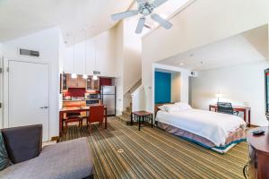a bedroom with a bed and a desk and a kitchen at Metro Phoenix Loft sleeps 6 in Phoenix