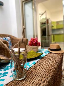 a table with a hat on top of a table at Alpha22 Apartment in Giardini Naxos