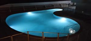 a large blue swimming pool at night with lights at Océano Fuerte in Costa de Antigua