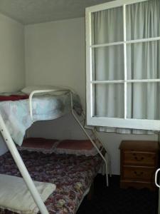 a room with a bunk bed and a window at 2 bdrm country cottage - The Bait - Rosewood cottages in Southampton