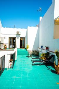 a patio with green tile on a white building at Marbella Village in Marbella