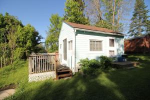 a small white tiny house in a yard at 1 Bdrm Country cottage #5 - Rosewood Cottages in Southampton