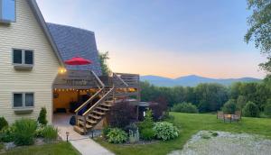 a house with a deck with a view of the mountains at 90 acre Indescribable Mountain View Getaway! Hot Tub - Pool Table - Fire Pit - Games! in Shrewsbury