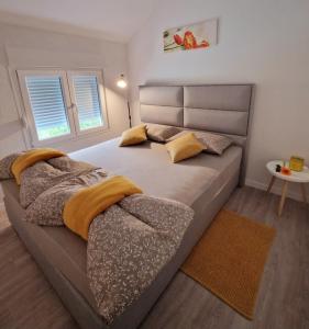 a bedroom with a large bed with two pillows at APP & Beauty Loza in Zambratija