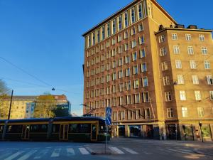 a bus is parked in front of a building at Pink Haven, Helsinki Center in Helsinki
