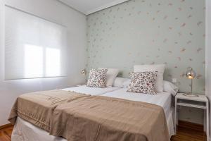 um quarto com uma cama grande com duas almofadas em MAD COCO Vintage Apartment Madrid em Madri