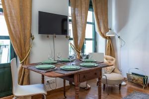 einen Esstisch mit Tellern und Weingläsern darauf in der Unterkunft MAD COCO Vintage Apartment Madrid in Madrid