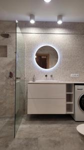 a bathroom with a sink and a mirror at Apartament Sienkiewicza 22 in Zamość