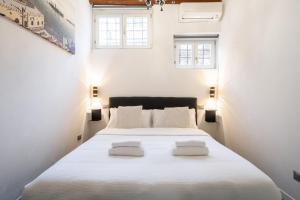 - une chambre avec un grand lit blanc et 2 oreillers blancs dans l'établissement Rialto Boutique Apartment, à Venise