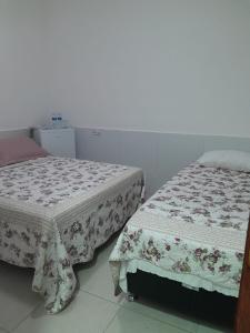 Postel nebo postele na pokoji v ubytování Recanto Suítes