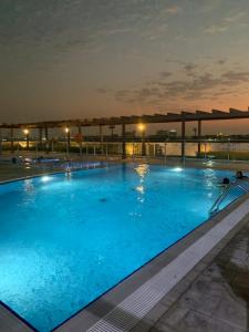 a large swimming pool at night at Super Studio in Dubai in Dubai