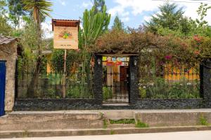 a fence with a sign in front of it at Kinti Wasi Casa de Campo in Los Baños del Inca
