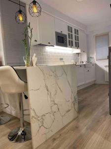 a kitchen with a marble counter top in a room at Apartamento a 100metros de la playa de San Lorenzo in Gijón