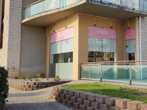 a building with a sign that reads sushi warehouse at The Surf Studio - Ericeira in Ericeira
