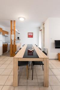 a dining room with a table in a kitchen at La Tour de Guet in Montbrun-les-Bains