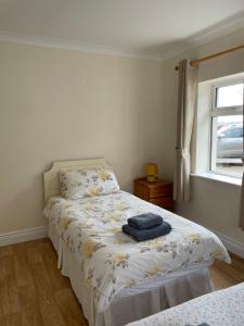 a bedroom with two beds and a window at Hillside House- Pine View in Ballinamuck