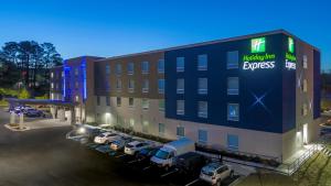 a large building with cars parked in a parking lot at Holiday Inn Express - Huntsville Space Center, an IHG Hotel in Huntsville