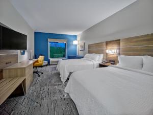 a hotel room with two beds and a flat screen tv at Holiday Inn Express - Huntsville Space Center, an IHG Hotel in Huntsville
