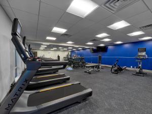 a gym with treadmills and a blue wall at Holiday Inn Express - Huntsville Space Center, an IHG Hotel in Huntsville