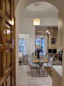 a dining room and living room with a table and chairs at MarGe Apt in Arta