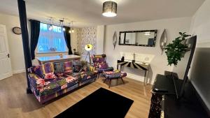 a living room with a couch and a table at Stylish & Cosy - Flat 6, Osborne Road in Pontypool