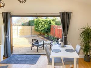 a dining room with a table and chairs and a patio at Woodside Retreat, Number 37 in Worthington