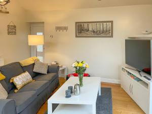 a living room with a couch and a tv at Woodside Retreat, Number 37 in Worthington