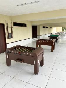 two pool tables in a room with billards at Monte Castelo Flat 08B in Sairé